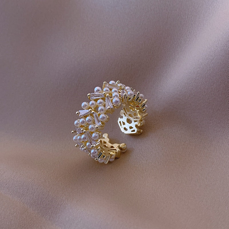 Pearl Zircon Gold Colour RingsM&H FashionM&H FashionThis classic style Pearl Zircon Gold Colour Rings is a must-have for any jewellery collection. Crafted from brass and featuring a pave setting, this ring is adorned Pearl Zircon Gold Colour Rings