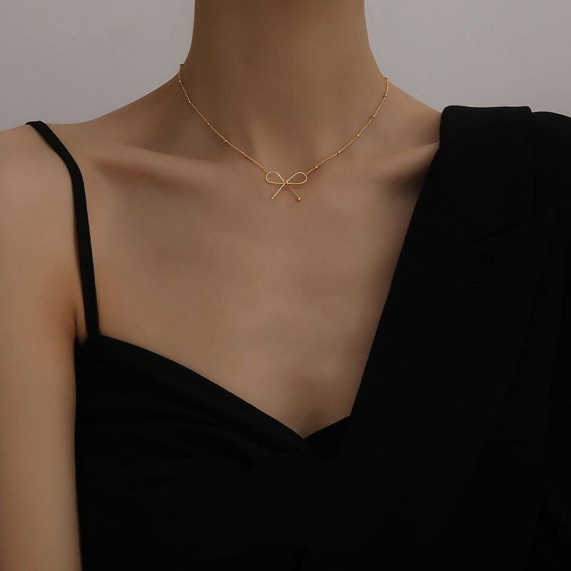 Stylish gold-plated bow charm necklace - M&H FashionStylish gold-plated bow charm necklaceM&H FashionM&H Fashion200001034:361180#N147Stylish gold-plated bow charm necklaceM&H FashionM&H FashionThis stylish gold-plated bow charm necklace is the perfect accessory for any outfit. It features a bowknot shape and is made of stainless steel and metal. The necklaStylish gold-plated bow charm necklace