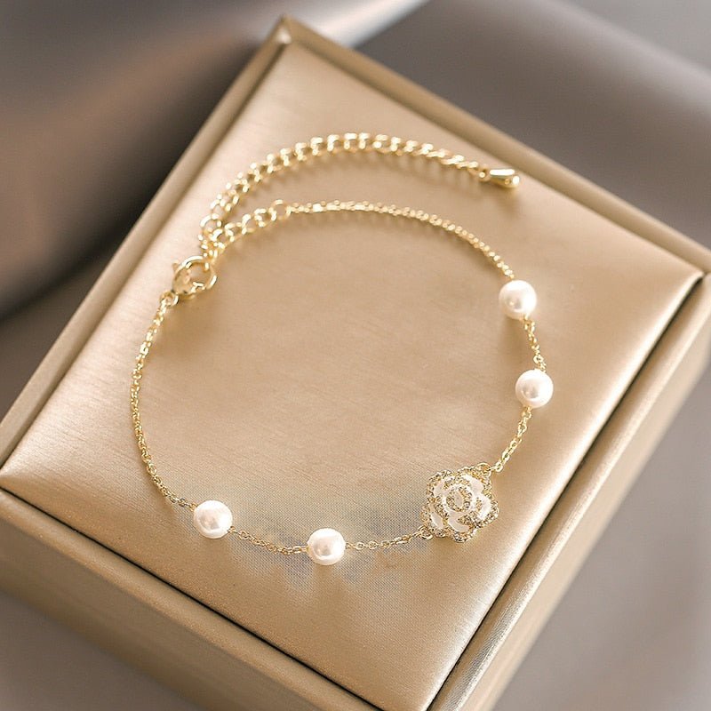 White Camellia Pearl Gold Bracelet - M&H FashionWhite Camellia Pearl Gold BraceletM&H FashionM&H Fashion200001034:361181White Camellia Pearl Gold BraceletM&H FashionM&H FashionThis White Camellia Pearl Gold Bracelet is a classic piece of jewelry. It is made of copper alloy and metal, and features a channel setting. The clasp type is a lobsWhite Camellia Pearl Gold Bracelet