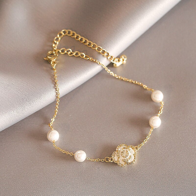 White Camellia Pearl Gold Bracelet - M&H FashionWhite Camellia Pearl Gold BraceletM&H FashionM&H Fashion200001034:361181White Camellia Pearl Gold BraceletM&H FashionM&H FashionThis White Camellia Pearl Gold Bracelet is a classic piece of jewelry. It is made of copper alloy and metal, and features a channel setting. The clasp type is a lobsWhite Camellia Pearl Gold Bracelet